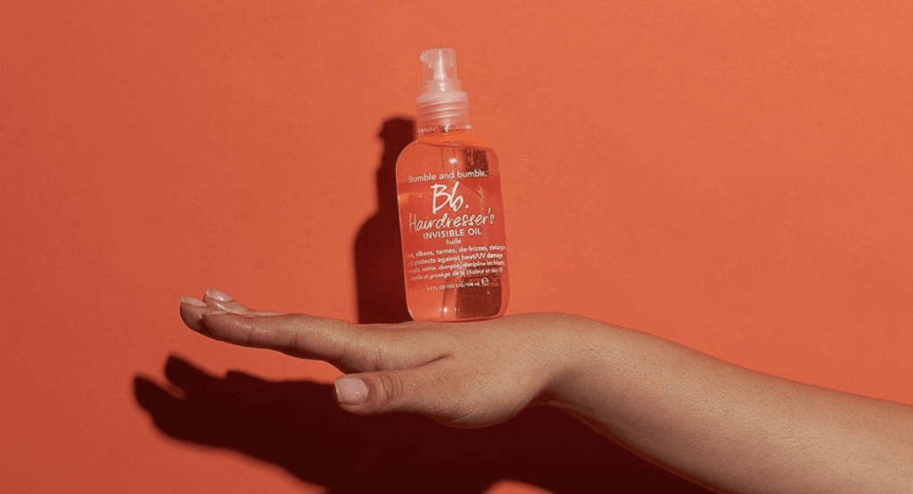 Bumble and Bumble's Invisible Oil in hand