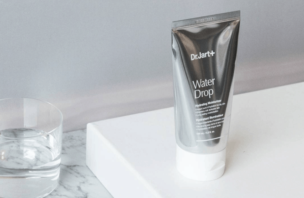 Dr. Jart Water Drop Hydrating Moisturizer with water glass.