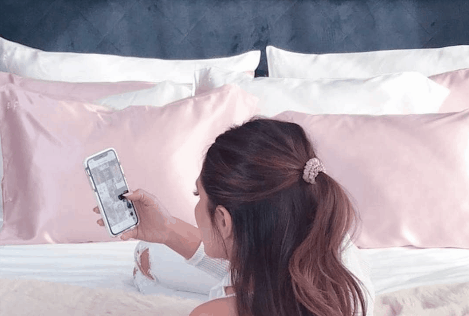 Slip Pillowcase Model with phone in bed